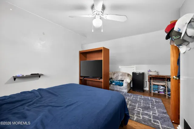 a bedroom with bed and a chandelier