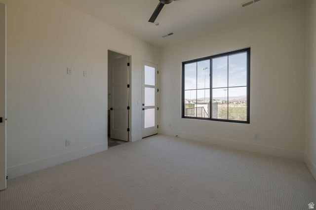 2281 South Crimson Cliffs Way St. George, UT 84790 - Photo 38 of 47 Unfurnished room featuring light colored carpet and a ceiling fan En suite