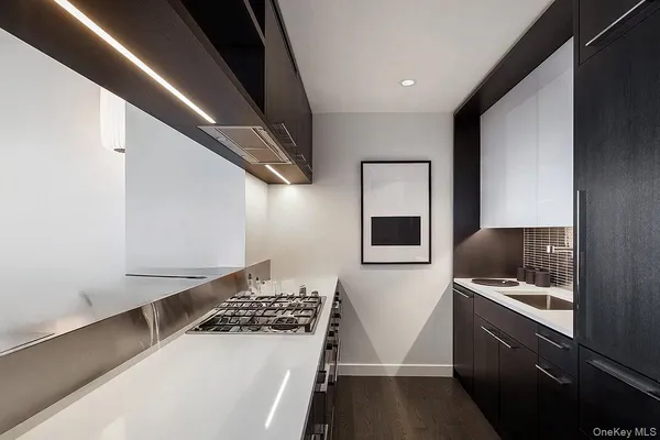 a kitchen with a sink and white cabinets
