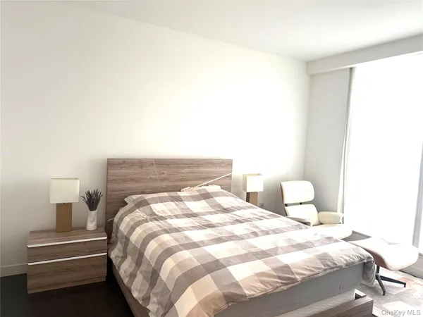 a bedroom with a bed and a lamp