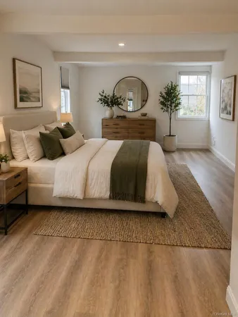 a bedroom with a large bed and a painting on the wall