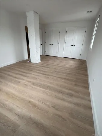 a view of a room with wooden floor