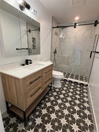 a bathroom with a sink toilet and shower