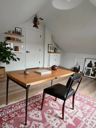 a room with table chairs and wooden floor