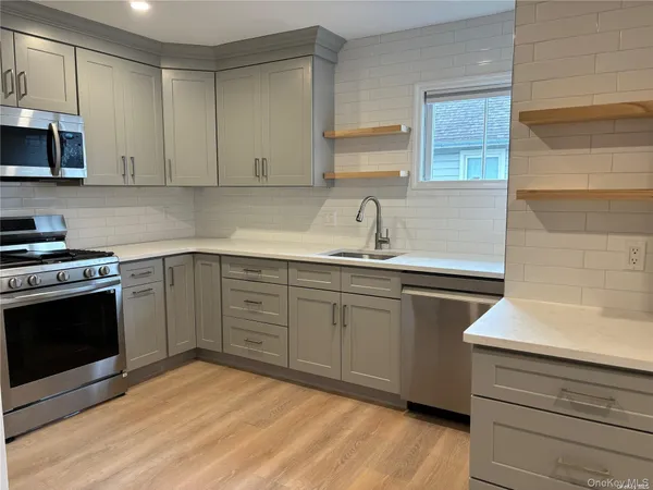 a kitchen with a sink stove and microwave
