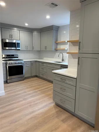 a kitchen with stainless steel appliances granite countertop a stove and a sink