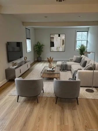 a living room with couches and a flat screen tv