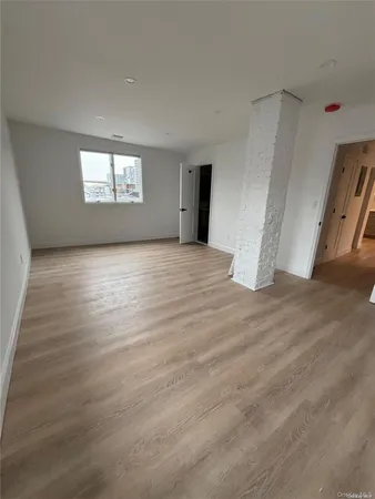 a view of an empty room and a window