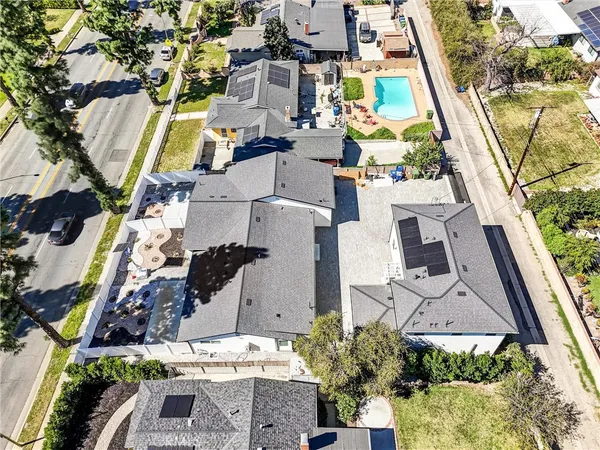 an aerial view of multiple houses with yard
