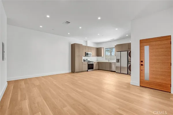 a view of kitchen with refrigerator and window