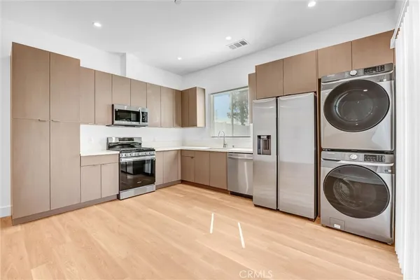 a kitchen with kitchen island a sink a stove a microwave and cabinets