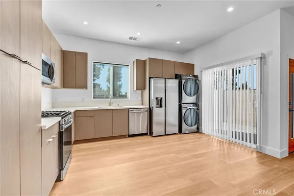 a kitchen with granite countertop a refrigerator and a sink