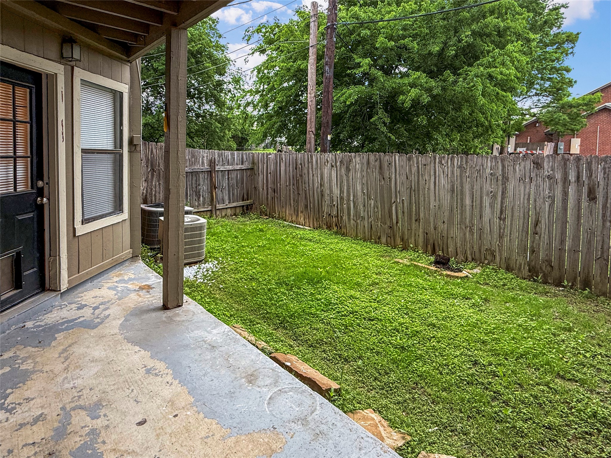 409 Rawhide Loop Round Rock, TX 78681 - Photo 11 of 14 Covered concrete patio with access to the grassy yard