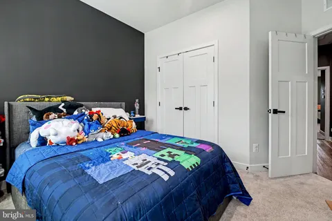 a bedroom with two beds and a couch