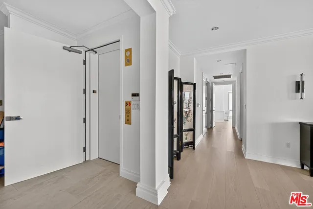 a view of a hallway with a wooden floor