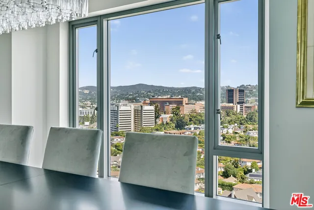 a view of a living room with a large window and wooden floor