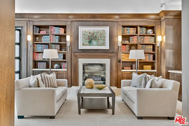 a living room with furniture fireplace and window