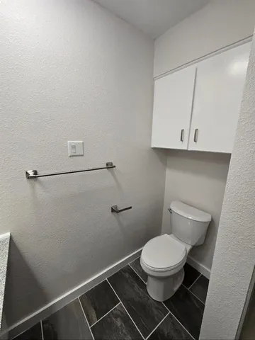 a white toilet sitting in a bathroom