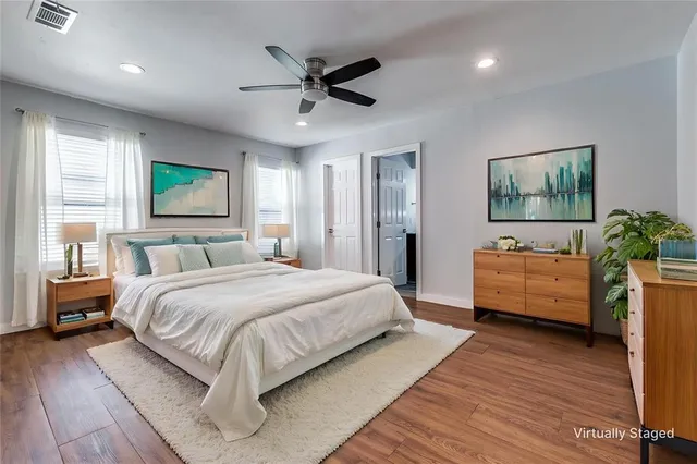 a bedroom with a large bed a chandelier and a couch