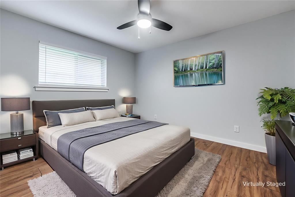 7739 Dentcrest Drive Dallas, TX 75254 - Photo 13 of 23 a bedroom with bed and a potted plant