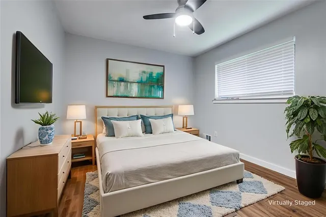 a bedroom with a bed and a potted plant