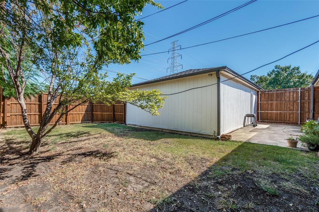 7739 Dentcrest Drive Dallas, TX 75254 - Photo 16 of 23 a backyard of a house with plants and a tree