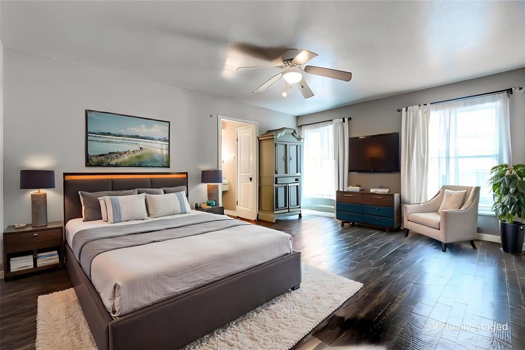 7739 Dentcrest Drive Dallas, TX 75254 - Photo 20 of 23 a spacious bedroom with a bed and a flat screen television