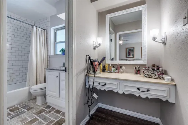 a spacious bathroom with a toilet sink a mirror and shower