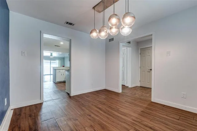a view of a chandelier and wooden floor
