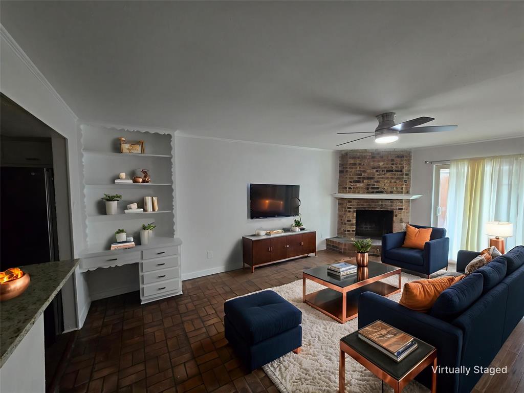 7739 Dentcrest Drive Dallas, TX 75254 - Photo 9 of 23 a living room with furniture a flat screen tv and a fireplace