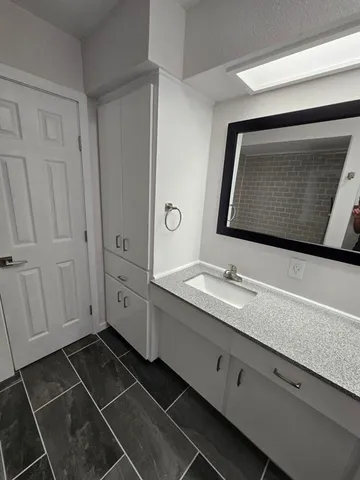 a bathroom with a double vanity sink and mirror