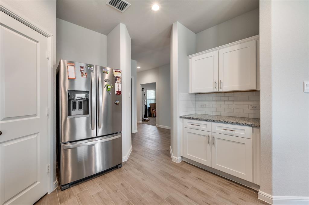 9628 Austin Holw Road Fort Worth, TX 76036 - Photo 18 of 37 a kitchen with stainless steel appliances a refrigerator sink and cabinets