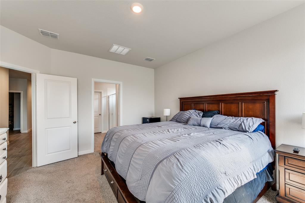 9628 Austin Holw Road Fort Worth, TX 76036 - Photo 20 of 37 a bedroom with a bed and a mirror