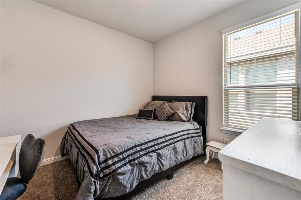 9628 Austin Holw Road Fort Worth, TX 76036 - Photo 29 of 37 a bedroom with a bed and a table