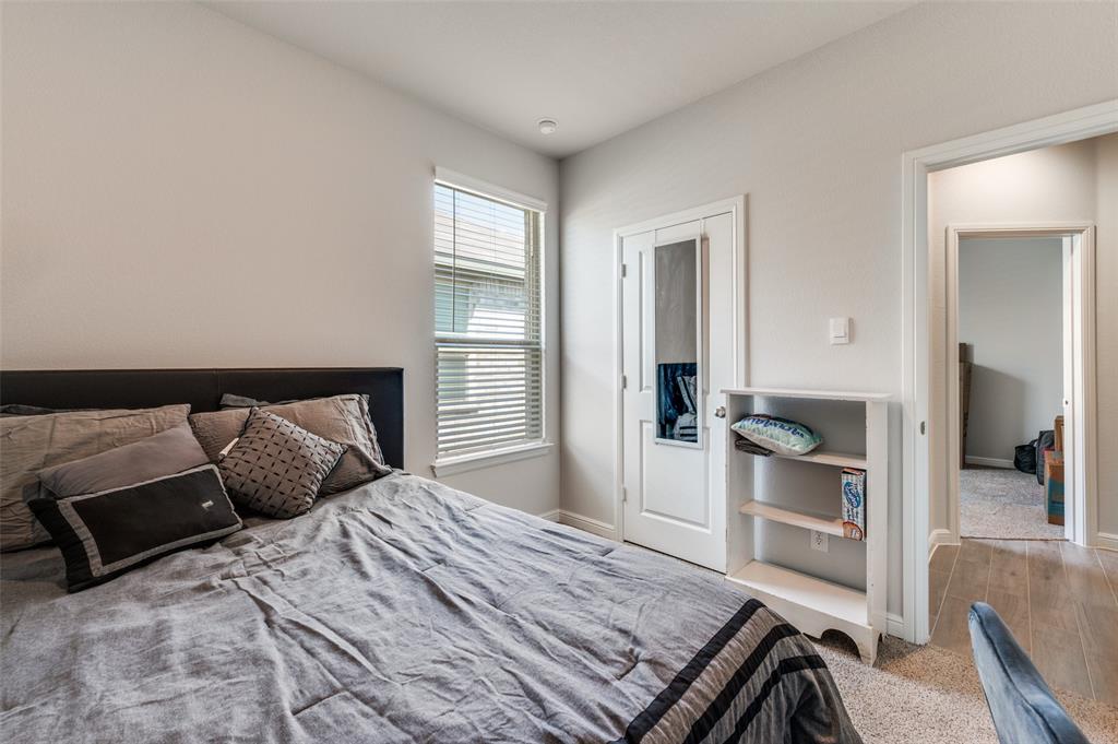 9628 Austin Holw Road Fort Worth, TX 76036 - Photo 30 of 37 a bedroom with a bed and wooden floor