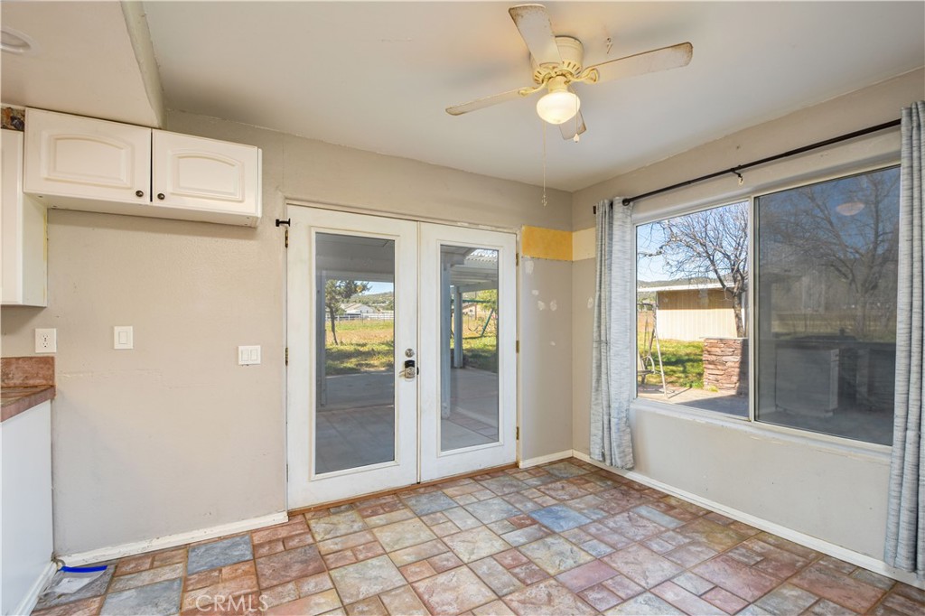 40520 Lake Riverside Drive Aguanga, CA 92536 - Photo 11 of 36 a view of an empty room with window and chandelier fan