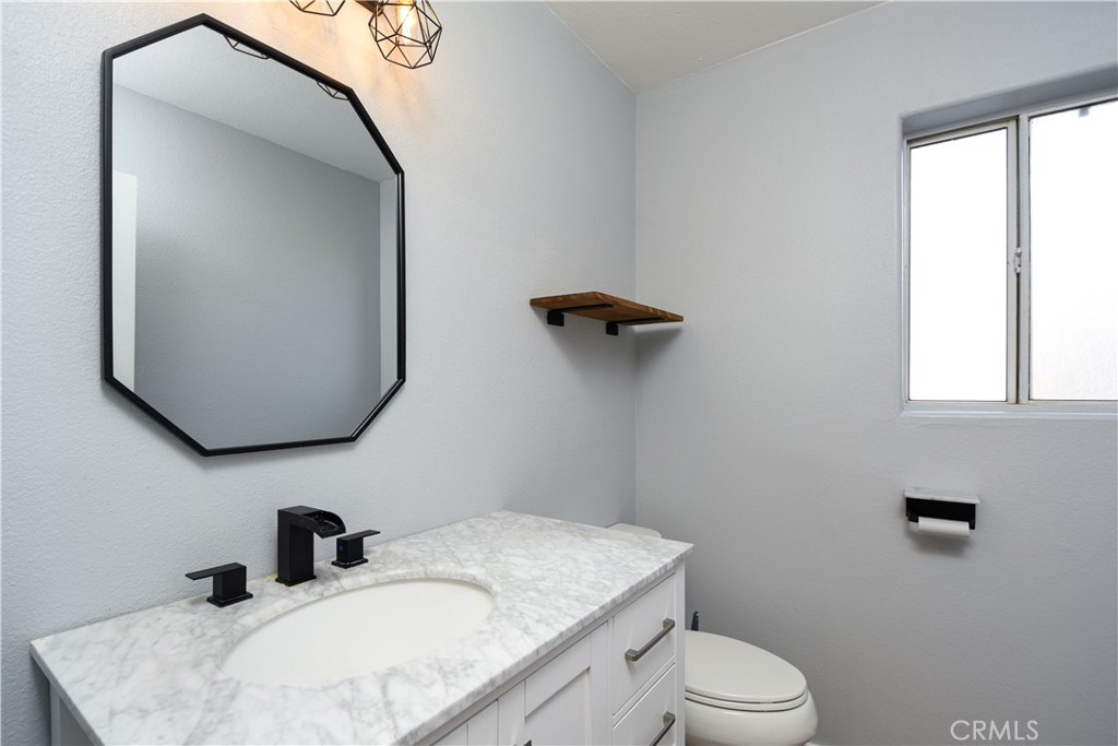 40520 Lake Riverside Drive Aguanga, CA 92536 - Photo 12 of 36 a bathroom with a sink toilet and mirror
