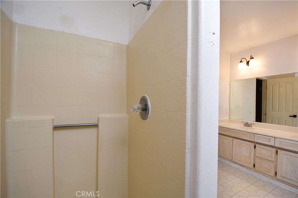 40520 Lake Riverside Drive Aguanga, CA 92536 - Photo 18 of 36 a bathroom with a double vanity sink and a mirror