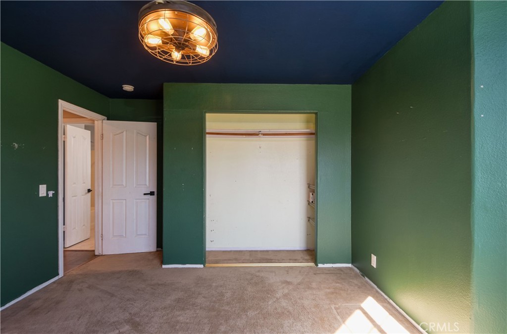 40520 Lake Riverside Drive Aguanga, CA 92536 - Photo 21 of 36 a view of an empty room with a window and a fireplace