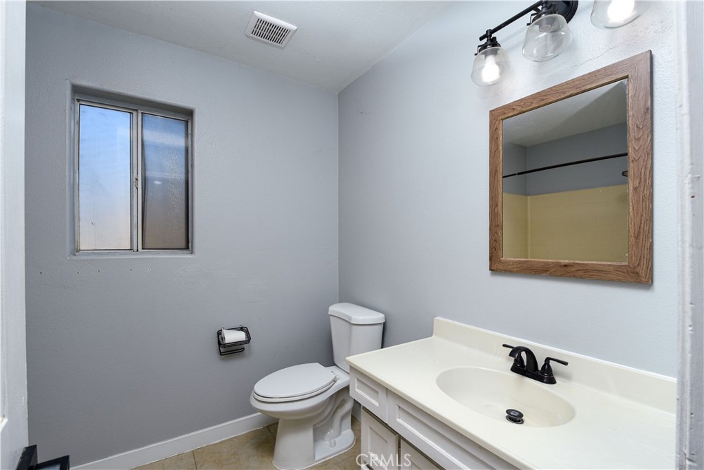 40520 Lake Riverside Drive Aguanga, CA 92536 - Photo 22 of 36 a bathroom with a sink mirror and toilet