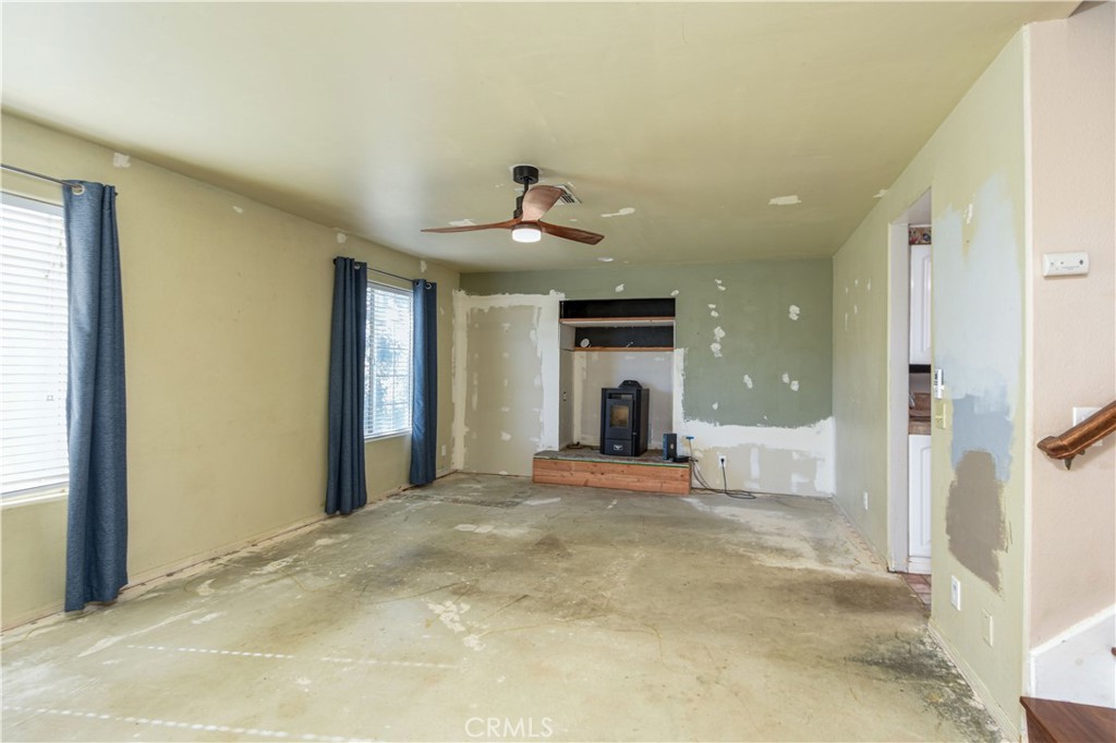 40520 Lake Riverside Drive Aguanga, CA 92536 - Photo 4 of 36 a view of an empty room with a fireplace and a window
