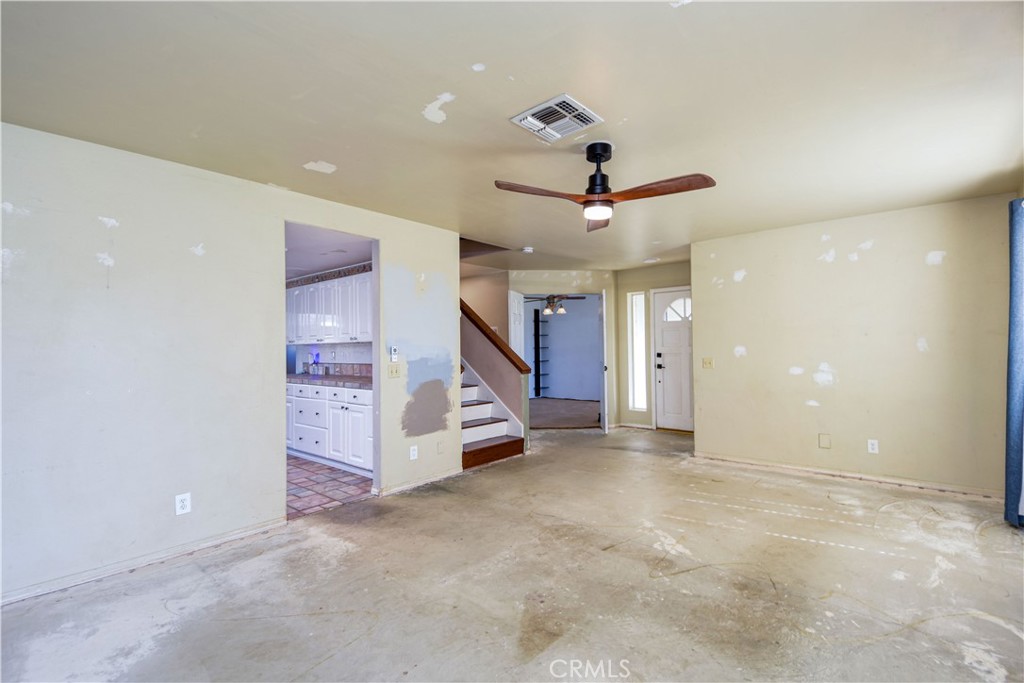 40520 Lake Riverside Drive Aguanga, CA 92536 - Photo 5 of 36 an empty room with windows and ceiling fan