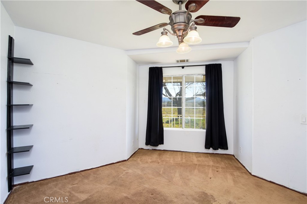 40520 Lake Riverside Drive Aguanga, CA 92536 - Photo 8 of 36 a view of an empty room with a window