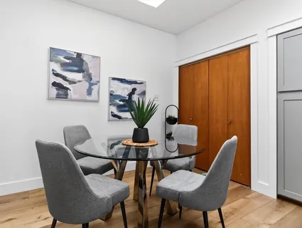 a dining room with furniture and wooden floor