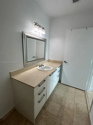 a bathroom with a sink vanity and granite