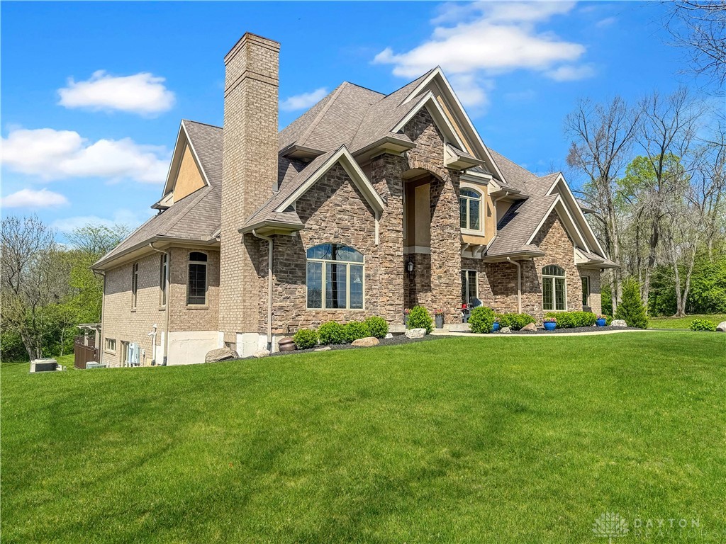 4096 Middle Urbana Road Urbana, OH 43078 - Photo 13 of 96 This grand residence showcases a charming facade with brick and stone, nestled amidst lush landscaping.