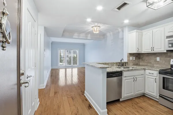 a kitchen with a stove and white cabinets