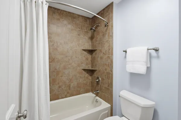 a bathroom with a shower and a toilet