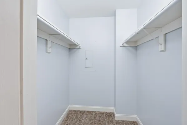 a view of walk in closet with empty racks
