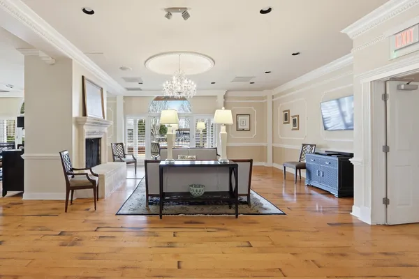 a living room with fireplace furniture and a chandelier